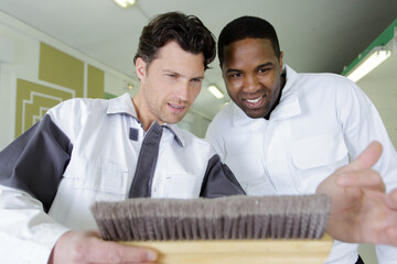 happy colleagues are checking a brush