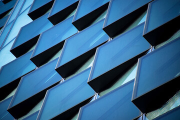 Angular abstract glass rectangles on the side of an office building
