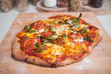 Most beautiful and delicious homemade vegetarian pizza just getting out of the pizza oven. Professional italian cooking. Wooden board.