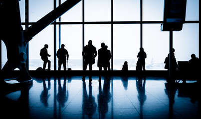 Silhouettes of People in the Airport Terminal Lounge