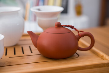 Beautiful brown clay teapot on a bambou tray. Used for Gong Fu Cha. Traditional asian way of drinking the hot beverage.