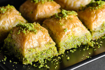 Traditional turkish dessert antep baklava with pistachio on rustic table,  ramadan or holiday...