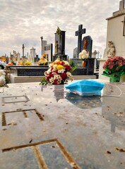 face mask, mask, rest in peace, rest, cemetery, graveyard, bunch, bouquet, cross, gravestone, tombstone, tomb, niche, flower, view, skyline, sky, grave, blue, downtown, europe, old, outdoor, unhappy e