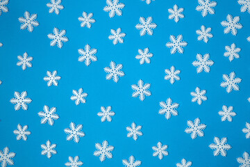 Christmas snowflake composition.Snowflakes on a blue background.Creative minimal Christmas art.Flat lay, copy space, above.
