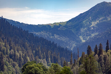 Obraz premium Brown round vintage old street lamp against the backdrop of mountains and blue sky with blurry background, used as a background or texture, soft focus