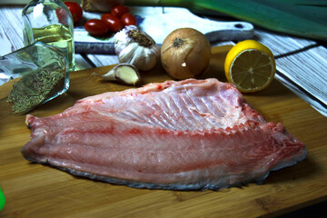 Raw fresh carp fish fillet on a cutting board. Cooking background.