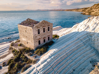 Punta Bianca, Agrigento in Sicily Italy White beach with old ruins of an abandoned stone house on...