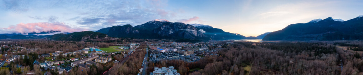 Aerial Panoramic View of Residential Homes in a touristic city. Colorful Sunset Sky. Taken in Squamish, North of Vancouver, British Columbia, Canada.