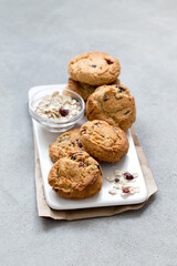 Multi-grain cookies with dried cranberries on a tray on a light gray background