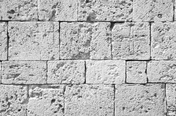 Fototapeta premium Background of ancient brick wall. Texture of old amphitheater stone for design. Monochrome.