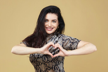 the attractive brunette folded her hands in the shape of a heart. photo session in the Studio on a...