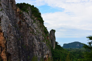 Beautiful scenery and sky with green trees, white and gold clouds. And the mountains before sunset the sunset from the top of the mountain