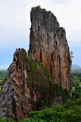Beautiful scenery and sky with green trees, white and gold clouds. And the mountains before sunset the sunset from the top of the mountain