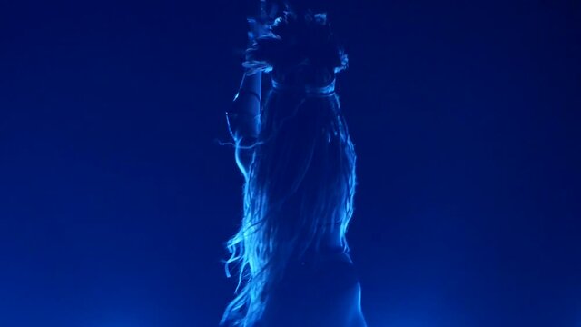Sexy gogo dancer is performing at a party, dancing in glowing lights, nightlife