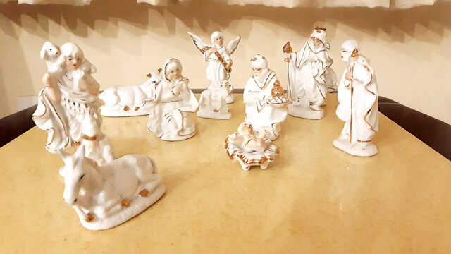 Christmas nativity scene with white statues and golden details
