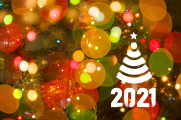 Christmas background-garlands with colorful lights on a decorated Christmas tree, bokeh, Happy New Year 2021 colored symbol and text in trendy flatten style design for seasonal holidays flyers.