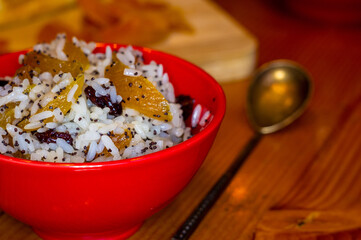 handmade preparation of treats for traditional Orthodox Christmas - rice pudding with fruits, cranberries, honey, nuts, Church candles