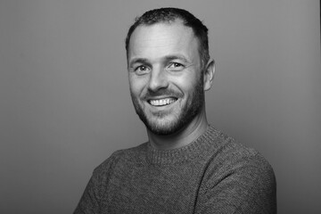Portrait of a man in front of a colored background