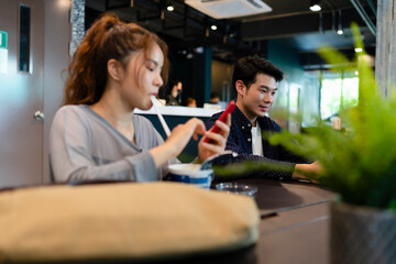 Man working outdoors at cafe bar with partner.