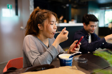 Asian woman enjoy eating lunch box at the bar.