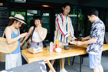 Group of tourist people enjoy eating snack in summer party at hotel lounge.