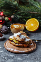New Year's breakfast with croissants. New Year's croissant with chocolate and baked orange