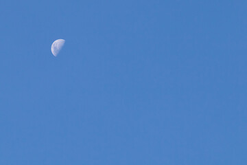 Crescent moon in the blue sky. Minimalism