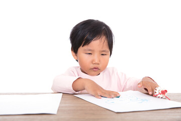 Naklejka premium Chinese girl painting with paintbrush in hand lying on the table in front of white background