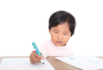 Cute little Chinese girl drawing on the table in front of white background