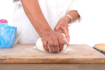 Pastry chef kneading dough on the table, close-up