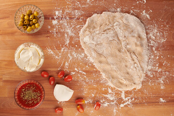 Making italian pizza step by step: pizza dough rolled out