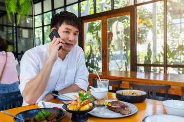 man talking on a mobile phone in restaurant