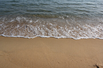 Soft beautiful ocean wave on sandy beach. Background