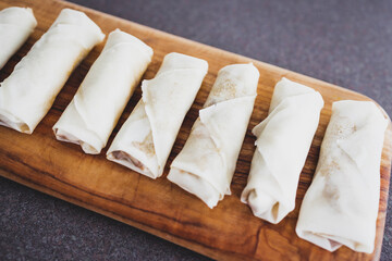 plant-based food, vegan homemade spring rolls with stir fried vegetables filling before geting cooked