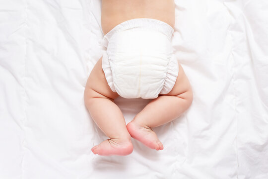 Cute Caucasian Infant Baby In White Nappy On Light Grey Blanket. Top View. Banner Format. Copy Space. Diaper Change And Care Of Baby's Skin. 