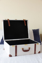 Empty vintage style travel baggage on bed