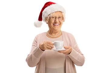 Cheerful elderly woman holding a cup and wearing a christmas santa hat