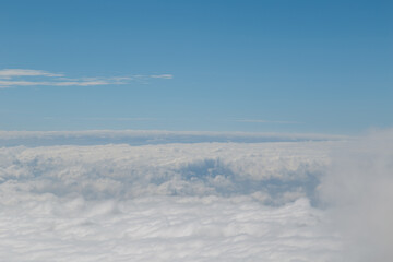 Fototapeta premium High angle shot of forest on hills covered with clouds