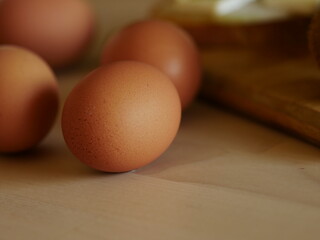 eggs on a wooden table with breakfast - glass of milk, wooden board, break with cheese