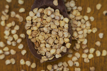 lots of chili and paprika seeds to sow on a wooden teaspoon