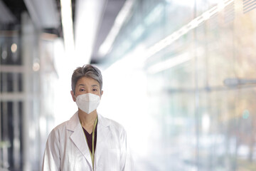 マスクをつけたシニア世代の日本人女性医師