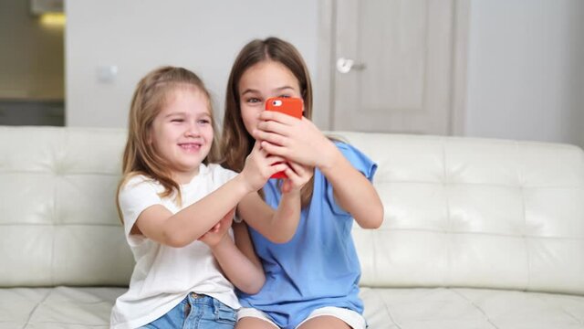 cheerful girls take selfies, communicate via video communication over Internet