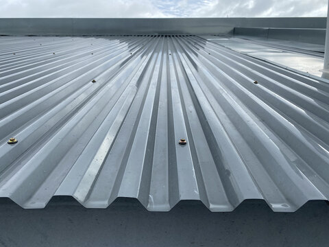 Close up of a corrugated metal deck roof system just installed on a building