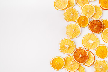 Christmas, winter, new year composition. Slices of dry oranges on white background. Natural Citrus fruits pattern. Food background. Flat lay, top view, copy space