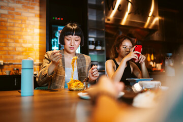 Young business woman take a break having lunch together in modern office.