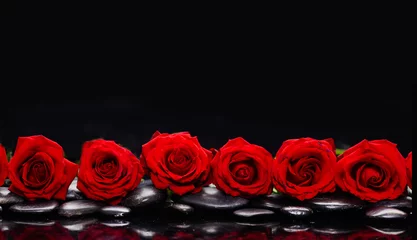 Gordijnen spa still life of with six red rose and zen black stones , wet on background © Mee Ting