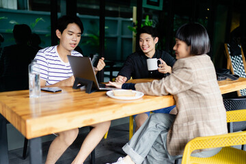 Group of asian business people planning project at cafe.