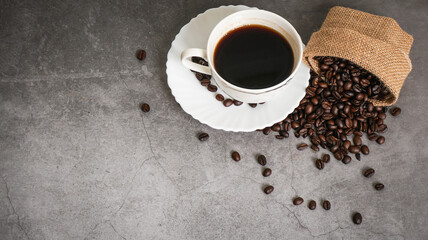 Coffee cup and beans on old kitchen table. Top view with copyspace for your text