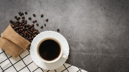 Coffee cup and beans on old kitchen table. Top view with copyspace for your text