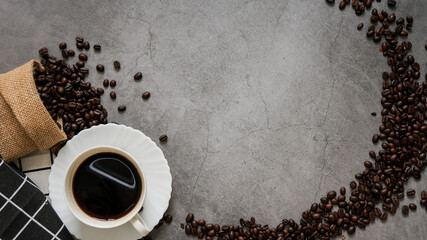 Coffee cup and beans on old kitchen table. Top view with copyspace for your text